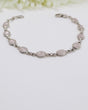 Delicate sterling silver Rose Quartz bracelet with soft pink gemstones displayed beside ruler for size reference.