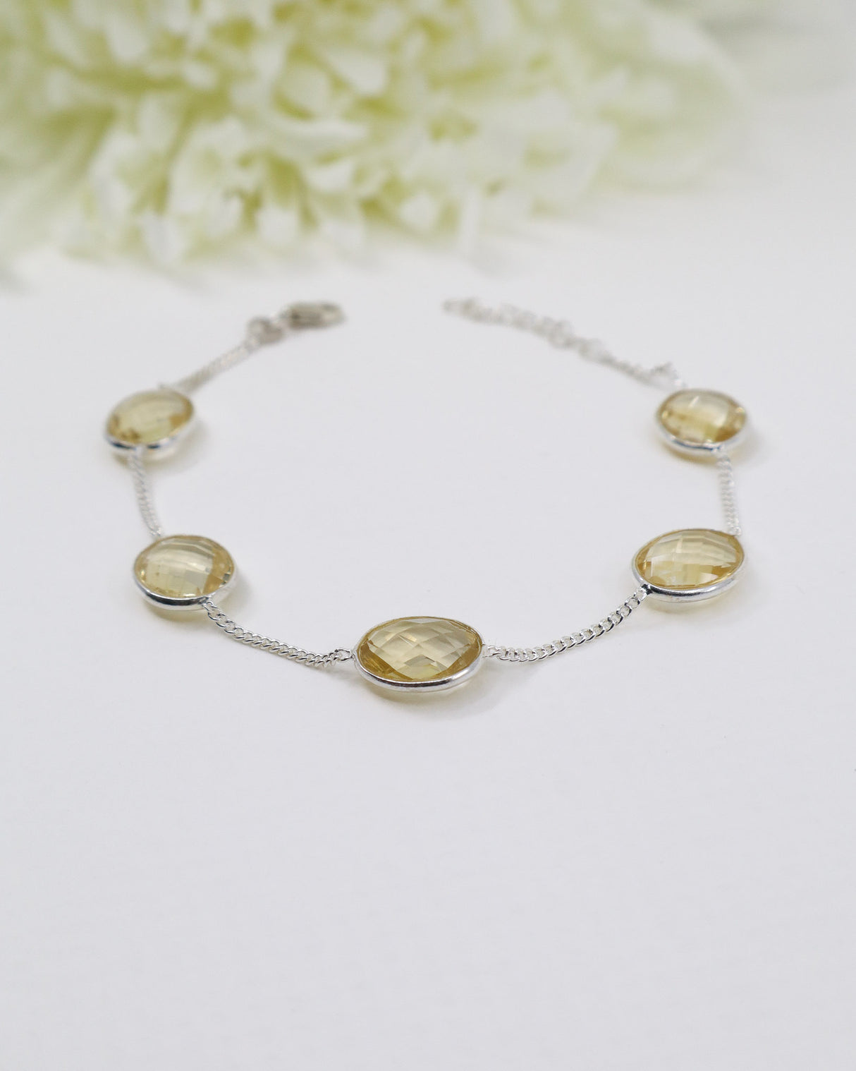 Sterling silver Citrine gemstone bracelet with faceted golden stones displayed beside ruler for size reference.