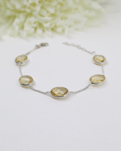 Sterling silver Citrine gemstone bracelet with faceted golden stones displayed beside ruler for size reference.