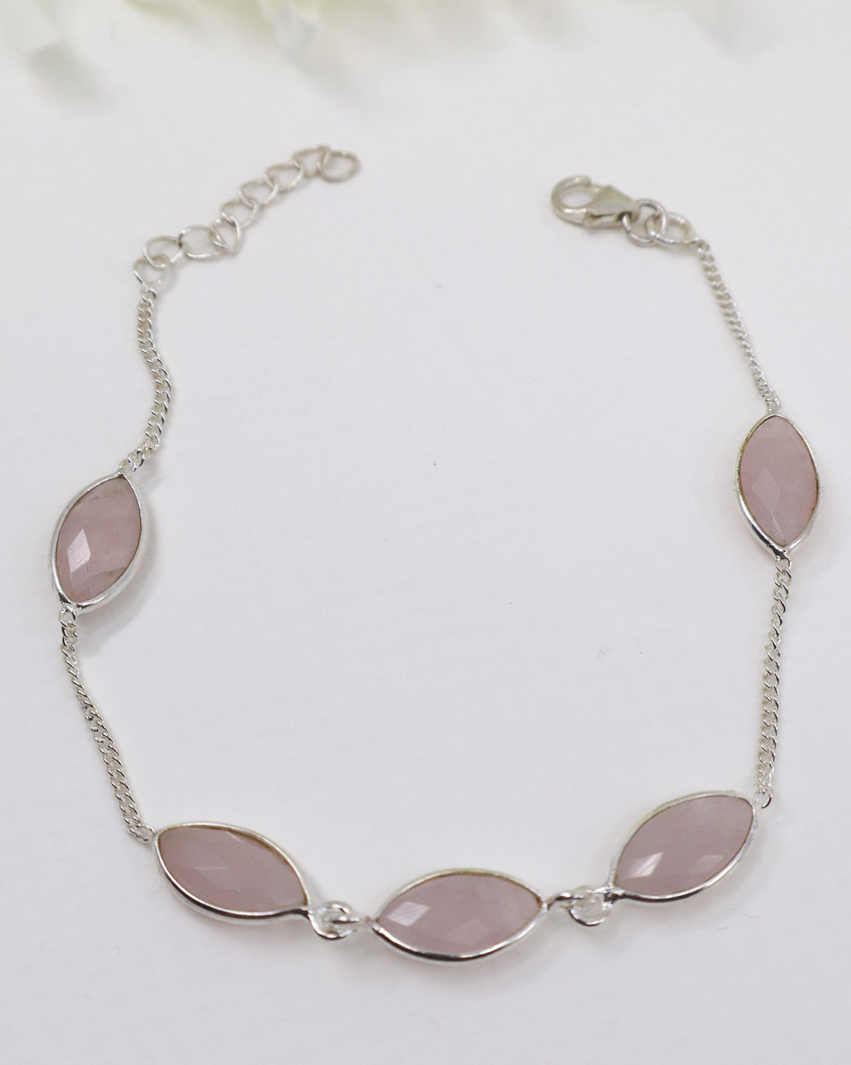 Sterling silver Rose Quartz gemstone bracelet with soft pink marquise-shaped stones displayed beside ruler for size reference.