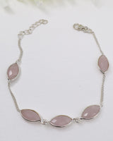 Sterling silver Rose Quartz gemstone bracelet with soft pink marquise-shaped stones displayed beside ruler for size reference.