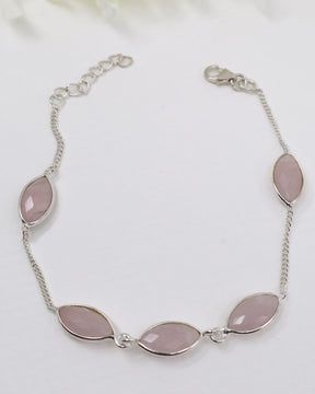 Sterling silver Rose Quartz gemstone bracelet with soft pink marquise-shaped stones displayed beside ruler for size reference.