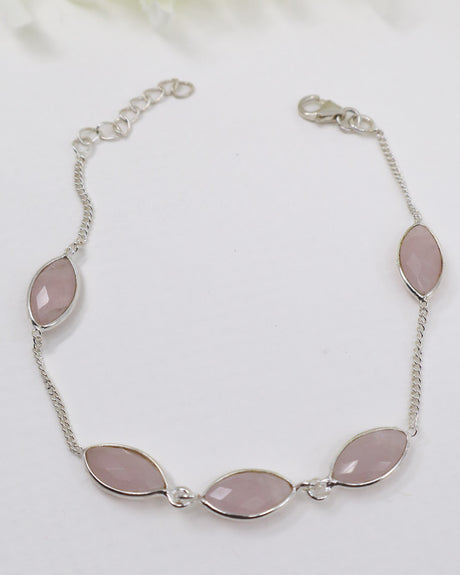 Sterling silver Rose Quartz gemstone bracelet with soft pink marquise-shaped stones displayed beside ruler for size reference.