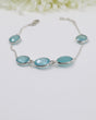 Sterling silver Blue Chalcedony gemstone bracelet with soft blue faceted stones displayed beside ruler for size reference.