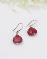 Faceted Indian Ruby sterling silver drop earrings with rich pink-red natural ruby gemstones photographed on a soft cream background by Inspired By 3 Australia.
