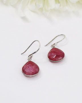Faceted Indian Ruby sterling silver drop earrings with rich pink-red natural ruby gemstones photographed on a soft cream background by Inspired By 3 Australia.