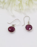 Natural faceted Indian Ruby sterling silver earrings with deep pink and crimson gemstones photographed on a soft cream background by Inspired By 3 Australia.