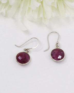 Natural faceted Indian Ruby sterling silver earrings with deep pink and crimson gemstones photographed on a soft cream background by Inspired By 3 Australia.