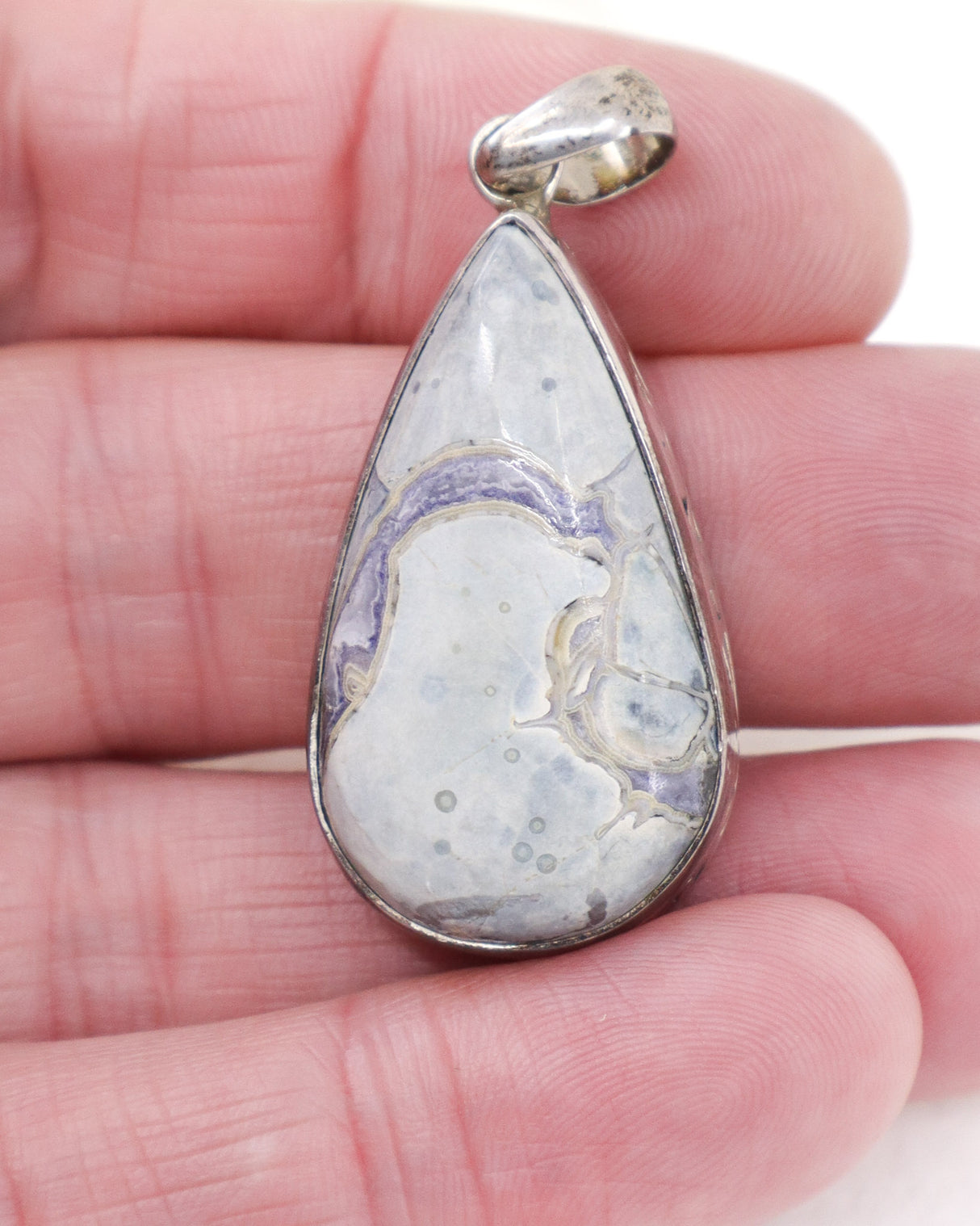 Sterling silver Orbicular Ocean Jasper pendant with soft cream, grey and lavender natural patterns in polished teardrop shape.