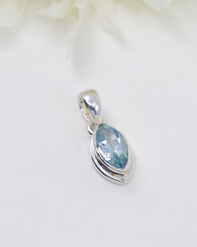 Blue Topaz .925 sterling silver marquise pendant with faceted pale blue gemstone and polished silver setting.