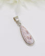Pink Natrolite “Pink Larimar” sterling silver elongated teardrop pendant with soft blush marbled gemstone.