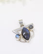 Sterling silver Labradorite pendant with marquise-shaped blue flash gemstone and smaller Labradorite accents on white background.