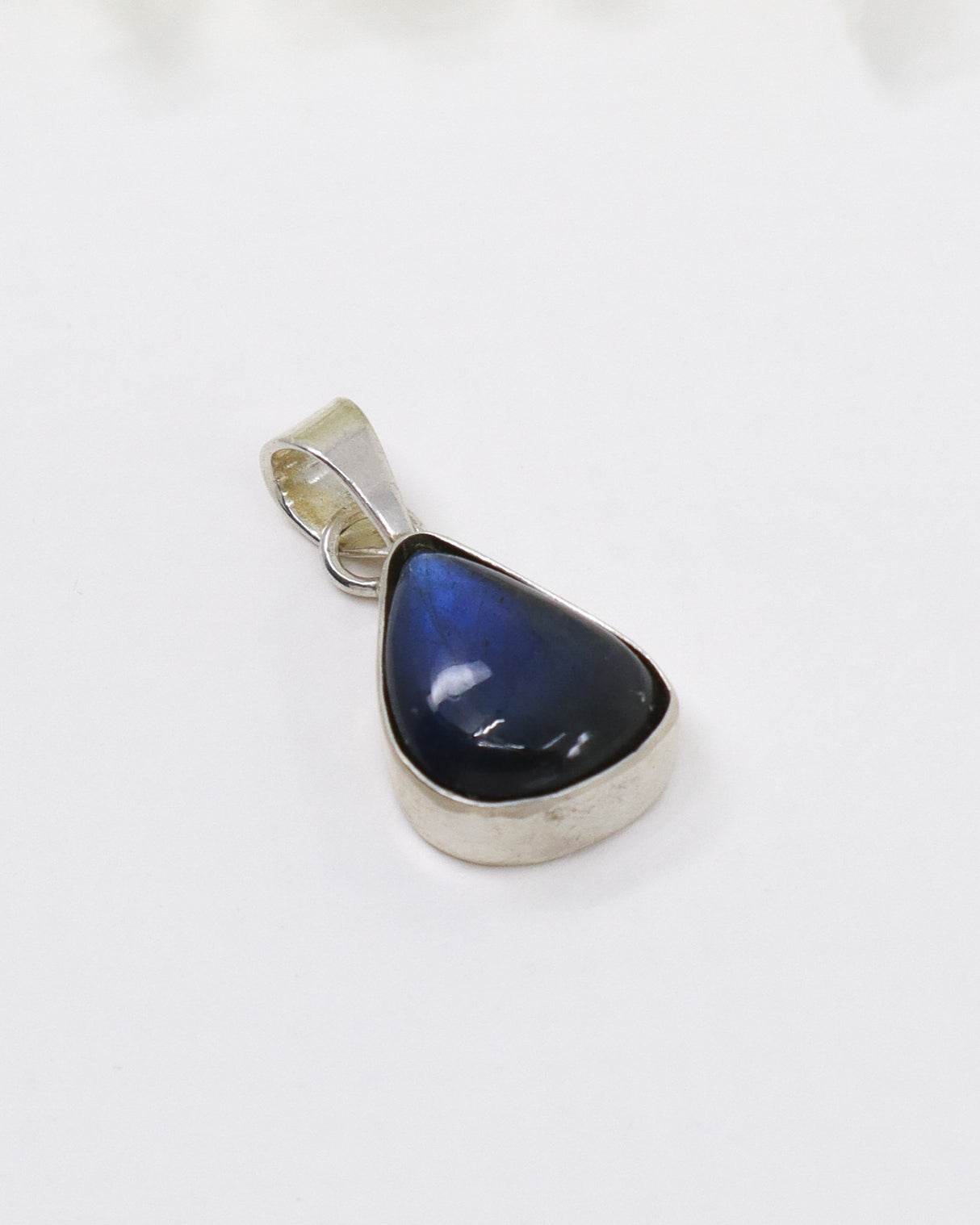 Sterling silver Labradorite pendant featuring vivid blue flash in polished teardrop gemstone setting.