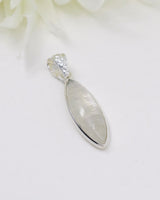 Elegant marquise-shaped Rainbow Moonstone sterling silver pendant with soft white and blue flash on a white background.