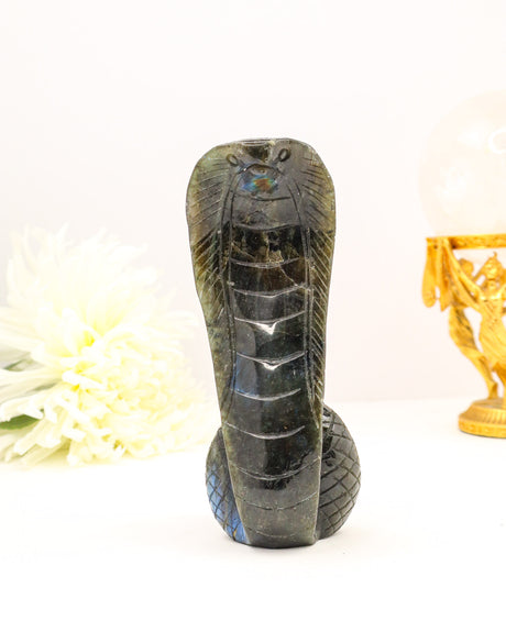 Hand carved Labradorite snake crystal with natural flash, symbolising protection, transformation and spiritual awakening