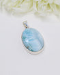 Large genuine Larimar silver pendant with ocean-blue natural patterns set in polished sterling silver.
