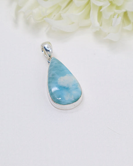 Teardrop Larimar silver pendant featuring dreamy sky-blue and white ocean-like marbling set in polished sterling silver bezel.