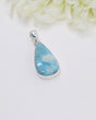 Teardrop Larimar silver pendant featuring dreamy sky-blue and white ocean-like marbling set in polished sterling silver bezel.