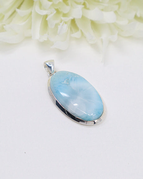 Large oval Larimar silver pendant with soft ocean-blue natural patterns set in polished sterling silver.