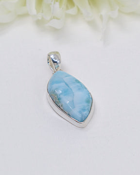 Pear shaped Larimar silver pendant with soft ocean-blue natural patterns set in polished sterling silver.