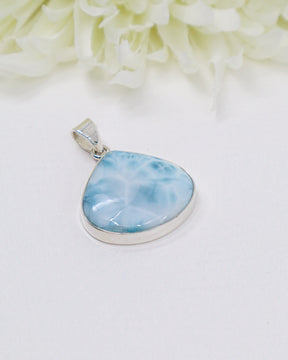 Teardrop shaped Larimar silver pendant with ocean-blue natural patterns set in polished sterling silver.