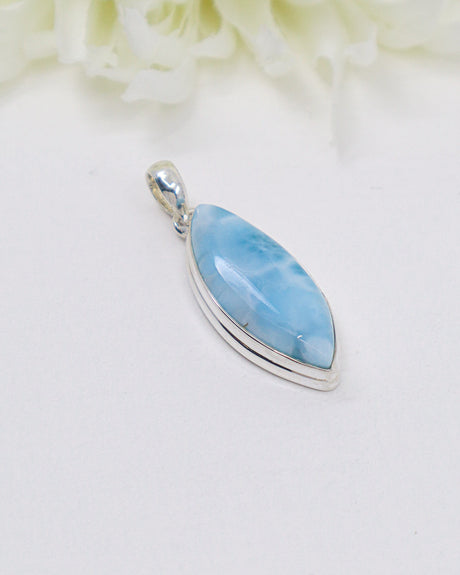 Marquise-shaped Larimar silver pendant featuring soft sky-blue and white ocean-like marbling set in polished sterling silver.