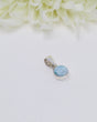 Petite round Larimar silver pendant featuring soft sky-blue and white ocean-like marbling set in polished sterling silver bezel.