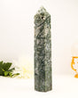 Large polished Moss Agate crystal tower with natural green patterns and sparkling druzy cavity.