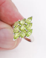 Natural Peridot sterling silver ring size 7 with multiple faceted marquise-cut green gemstones in a statement cluster setting.
