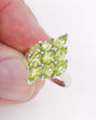 Natural Peridot sterling silver ring size 7 with multiple faceted marquise-cut green gemstones in a statement cluster setting.