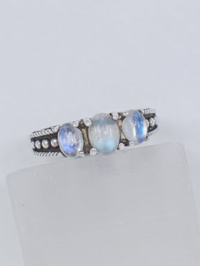 Natural Rainbow Moonstone sterling silver ring size 8 with three pearly white gemstones displaying blue flash in an ornate .925 silver setting.