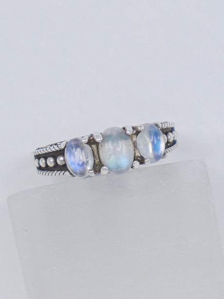 Natural Rainbow Moonstone sterling silver ring size 8 with three pearly white gemstones displaying blue flash in an ornate .925 silver setting.