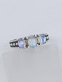 Natural Rainbow Moonstone sterling silver ring size 8 with three pearly white gemstones displaying blue flash in an ornate .925 silver setting.