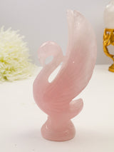 Large hand-carved Rose Quartz Swan 568g measuring 18cm with blush pink natural crystal, detailed raised wings and feather carving.