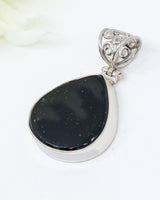 Natural Black Tourmaline sterling silver pendant with large polished black gemstone, ornate scrollwork bail and .925 silver setting.