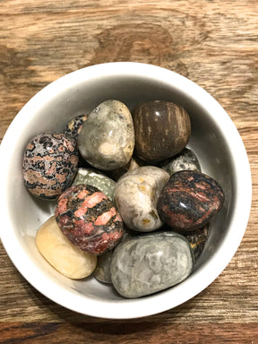 Ocean Jasper tumbled stone with swirling pink, green, and cream patterns — crystal of joy, renewal, and emotional healing.