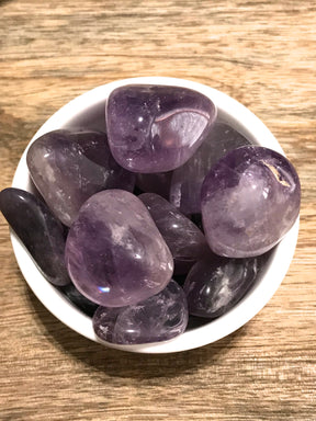 Amethyst tumbled stone in rich purple hues — crystal of peace, intuition, and spiritual protection.