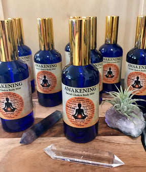 Awakening Chakra Mist in a 100ml glass bottle with gold atomiser, infused with Rose Bulgaria and Ylang Ylang oils, crystal-charged and Reiki-activated by Inspired By 3.
