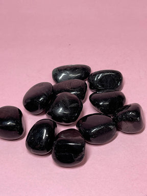 Hypersthene tumbled stone with metallic sheen — crystal of intuition, protection, and inner strength.