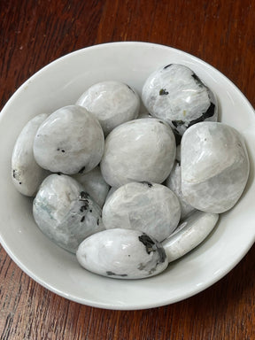 Rainbow Moonstone tumbled stone with flashes of blue and silver — crystal of intuition, divine light, and new beginnings.