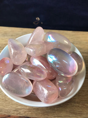Rose Aura Quartz tumbled stone with iridescent pink shimmer — crystal of divine love, joy, and emotional healing.