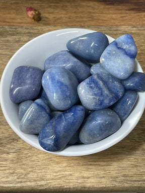 Blue Aventurine tumbled stone in soft indigo-blue tones — crystal of focus, strength, and spiritual insight.